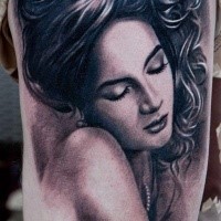 Black and gray style colored arm tattoo of seductive woman