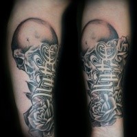 Black and gray style colored forearm tattoo of lettering with rose