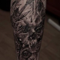 Black and gray style colored leg tattoo of human skull with eye and wings