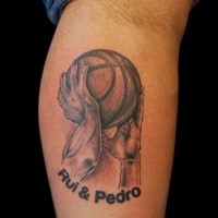 Black and gray style colored leg tattoo of hands holding ball and lettering