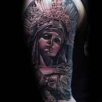 Black and gray style colored shoulder tattoo of saint woman statue