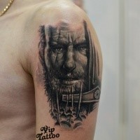 Black and gray style colored shoulder tattoo of old warrior with sword