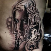 Black and gray style cool looking side tattoo of woman face with chess and ornaments