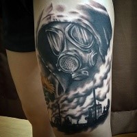 Black and gray style creepy looking  thigh tattoo of man in gas mask and wasteland