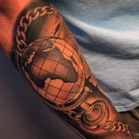 Black and gray style detailed arm tattoo of globe with chain