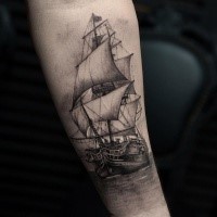 Black and gray style detailed arm tattoo of gorgeous sailing ship