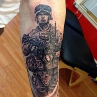 Black and gray style detailed leg tattoo of American soldier