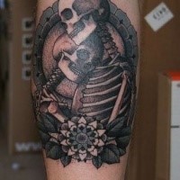 Black and gray style detailed leg tattoo of skeleton couple with flowers