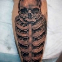 Black and gray style detailed leg tattoo of human skeleton