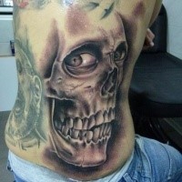 Black and gray style detailed side tattoo of human skull with eyes