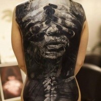 Black and gray style detailed whole back tattoo of woman face with hands