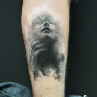 Black and gray style foggy forearm tattoo of mystic woman