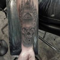 Black and gray style forearm tattoo of old cathedral with skull