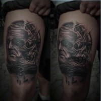 Black and gray style horror thigh tattoo of monster face with human skull
