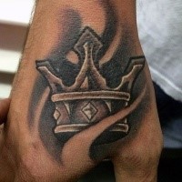Black and gray style impressive looking hand tattoo of crown