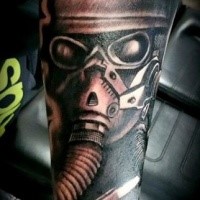 Black and gray style interesting looking man in gas mask tattoo on arm