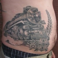 Black and gray style large belly tattoo of steam train with flowers
