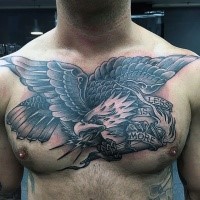 Black and gray style large chest tattoo of eagle and lettering