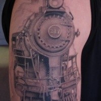 Black and gray style life like looking train tattoo on upper arm