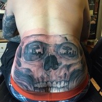 Black and gray style magnificent looking skull tattoo on back with bomb blast