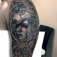 Black and gray style shoulder tattoo of woman with rose and wolf helmet