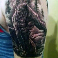 Black and gray style shoulder tattoo of werewolf in dark forest