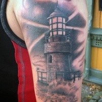 Black and gray style small old lighthouse and waves tattoo on shoulder