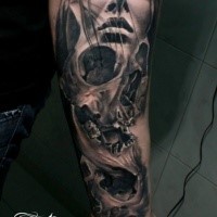 Black and gray style very detailed forearm tattoo of woman face with skull