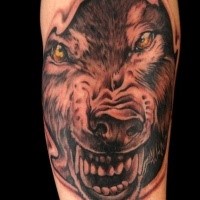 Black and gray style wolf face tattoo with yellow eyes