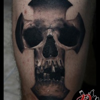Black and grey skull in cross tattoo