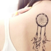 Black and white back tattoo of dream catcher