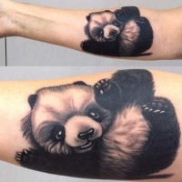 Black and white cute baby panda in playing mood tattoo on forearm