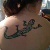 Black and white designed medium size lizard tattoo on girl's upper back