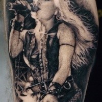Black and white detailed biceps tattoo of woman singer