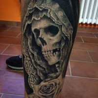 Black and white detailed leg tattoo of human skeleton in hood with rose