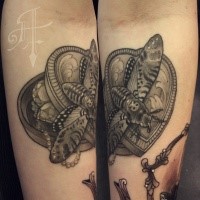 Black and white forearm tattoo of jewelry bow with butterfly