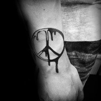 Black and white Pacific special symbol tattoo on outer forearm with paint drips