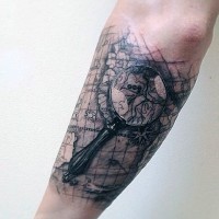 Black and white realistic lope with world map tattoo on arm