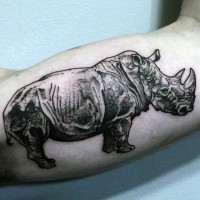 Black and white small natural looking biceps tattoo of rhino