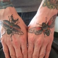 Schwarze Insekten Tattoo auf der Hand