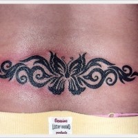 Black butterfly with patterns tattoo on lower back