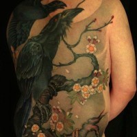 Black crows on a flowering tree tattoo