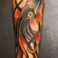 Black cuttlefish tattoo on arm