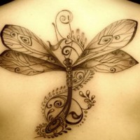 Black dragonfly tattoo on back