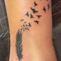 Black feather into birds tattoo on ankle