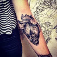 Black gray half herat half fish forearm tattoo
