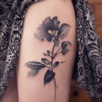 Black gray watercolor flower tattoo on thigh for women