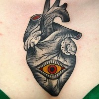 Black heart with red eye tattoo on chest