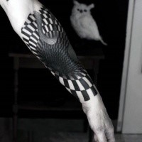 Black ink 3D style hypnotic ornament tattoo on forearm