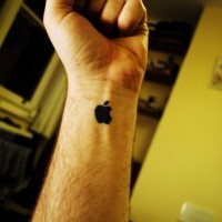 Black ink apple mac wrist tattoo